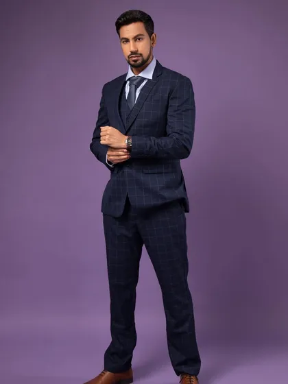 A confident, full-length pose. The simple act of adjusting a cufflink can make a shot feel more natural and less staged.