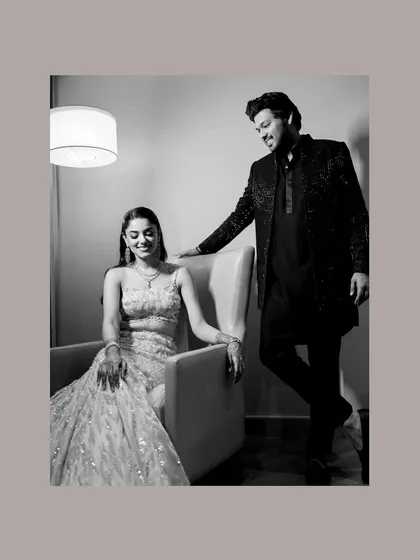 A sweet moment between the couple at their sangeet, he looking down at her with affection as she smiles.