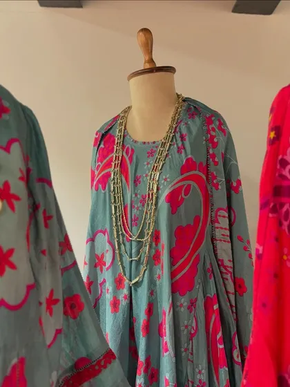 A view of two printed kaftans, one with a collar and the other with a simple round neck, showcasing the variety in my resort wear collection.