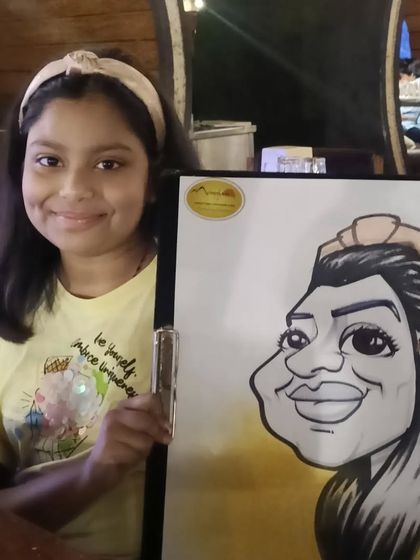 A young girl with her caricature at Mountain High.