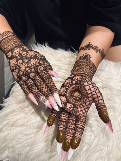 A unique asymmetrical design, with one hand featuring a lotus mandala and the other a dense floral pattern, showing how I can customize looks to your preference.