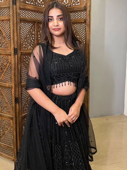 A simple and elegant pose in the black party wear lehenga. This shows how a pre-loved outfit can look effortlessly chic.