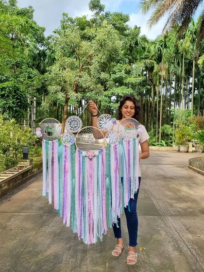 Our cluster dreamcatchers bring serenity to your space. Here is one of us holding a large pastel piece, ready to help your imagination soar with every delicate hue.