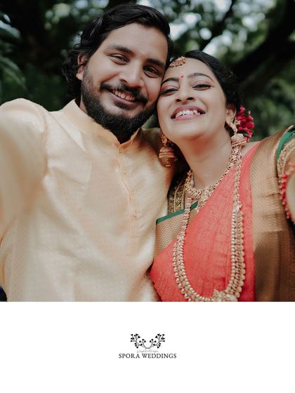 The couple taking a happy selfie together, a modern and fun moment during their traditional wedding celebration.