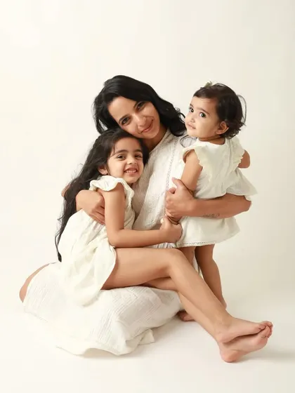 A beautiful portrait of a mother with her two girls. Their coordinated outfits and loving embrace make this a perfect keepsake.