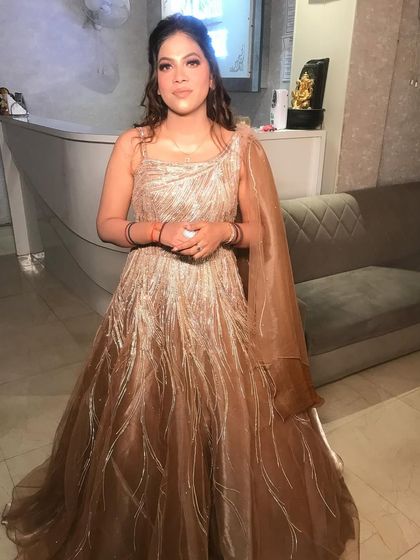 A full-length view of this gorgeous party look. The client is wearing a shimmering bronze gown, and we created a soft, glamorous makeup look with natural waves to complement it.