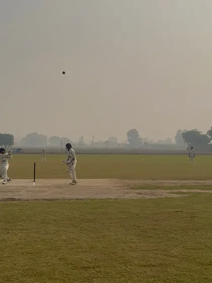 A batsman plays a shot, but the fielder is quick to react.