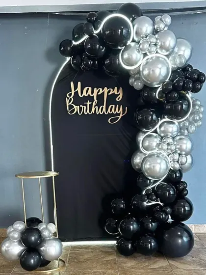A sleek and modern black and silver balloon arch. The clean lines of the arch and the metallic sheen of the balloons create a very contemporary and stylish look.