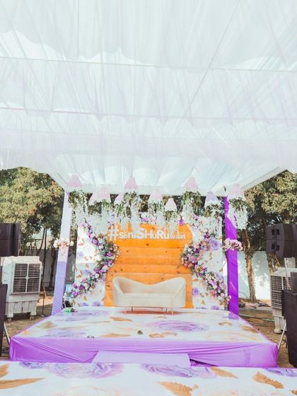 The main stage for the carnival-themed Mehendi, decorated in pastel purple and orange with a custom hashtag.