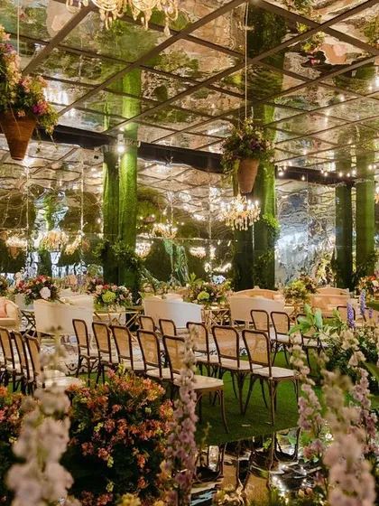 We love a challenge, and transforming an ancestral indoor hall into this magical, overgrown garden was a dream. With a mirrored ceiling reflecting thousands of blooms and chandeliers, we created an immersive environment to kick off the wedding festivities.