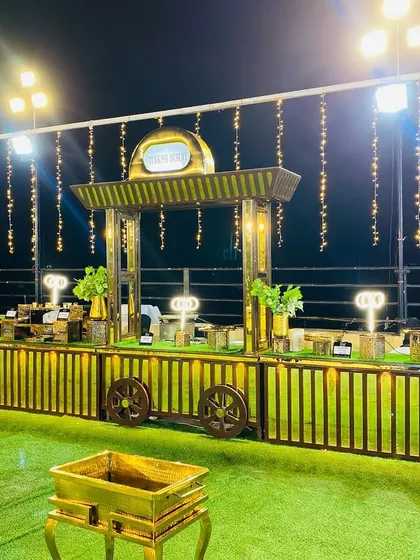 The beautiful golden counters illuminated by spotlights and hanging fairy lights at night.