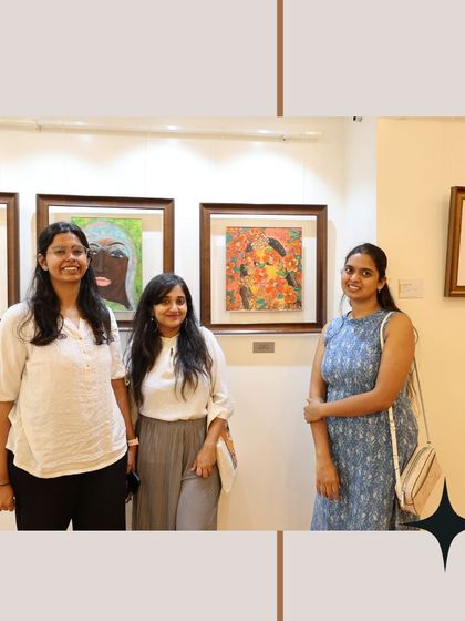 Three visitors smiling for a photo during their visit, showing the joy and connection that art can bring.