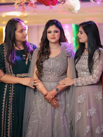 A candid moment of the bride with her friends or family, offering support and love on her big day.