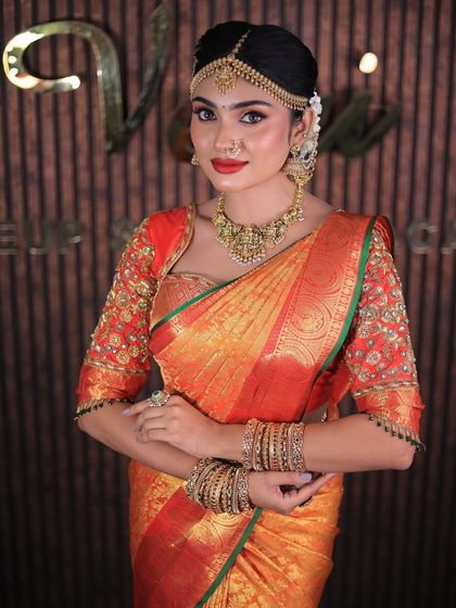 More shots of this gorgeous red and orange Kanchipuram saree. For photoshoots, I ensure every detail, from the pallu to the waist pleats, is absolutely perfect.