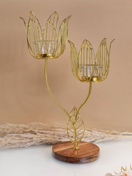 A decorative golden candle holder with a wooden base, styled with simple props. This type of shot is perfect for showing the product in a soft, appealing home setting.