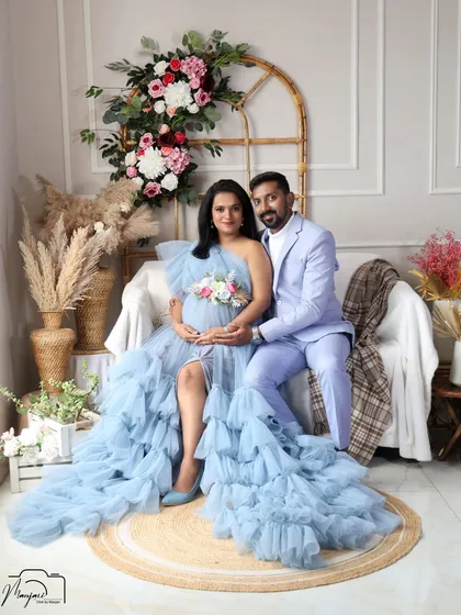 A classic seated portrait of the couple in the boho corner. They look so happy and connected as they await their baby.