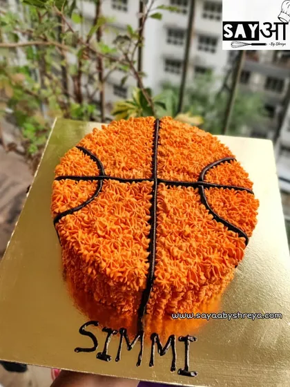 This basketball cake was a slam dunk for a sports-themed party. I used a star piping tip and orange buttercream to create the textured surface of the ball, making it a fun and visually striking dessert.