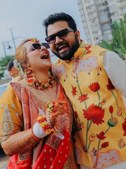 For me, the best shots are the unscripted ones. This candid photo from a Haldi ceremony captures a moment of pure, uninhibited laughter between the couple, showing the real fun and 'hasi-masti' of a wedding.