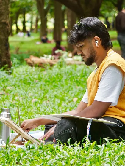 A focused moment, painting in the grass at Cubbon Park. With my headphones on, it's just me, the paper, and the sounds of the park. This is my form of meditation.