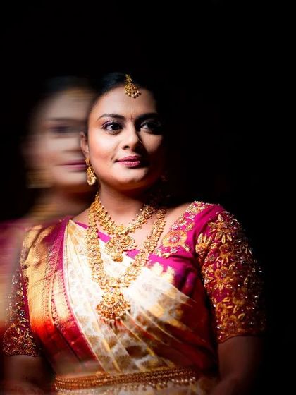 An artistic bridal portrait using motion blur to create a dreamy, ethereal effect, focusing on her traditional jewelry and attire.