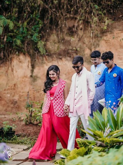 The couple leading their friends in a joyful procession during their outdoor Haldi event.