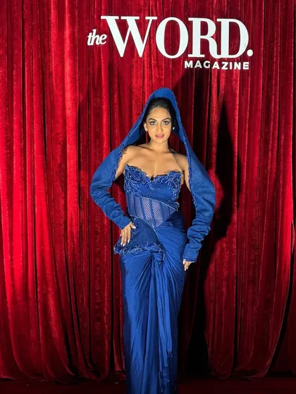 A client rocking my Active Blue gown with a mesh hood at a costume party, proving that high fashion can also be high fun.