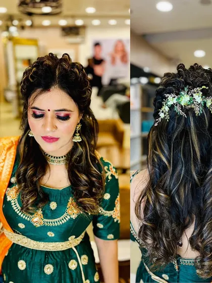 A detailed look at a party hairstyle. This image shows a beautiful half-updo with curls and floral accessories, perfect for a sangeet or mehendi function.