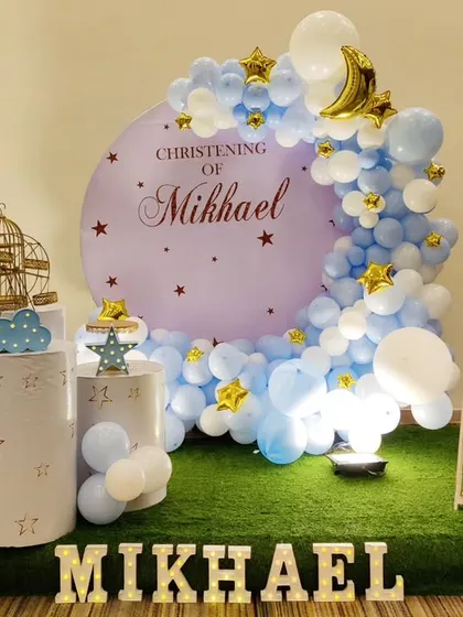 A serene and beautiful Christening setup for Mikhael. The decor features a "Twinkle Twinkle Little Star" theme with a blue and white color palette, a crescent moon backdrop, and star accents.