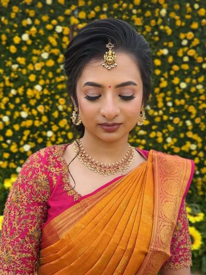 A close-up of this bride's elegant makeup against a backdrop of yellow flowers, highlighting the soft shimmer on her eyes.