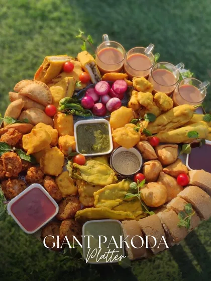 Another view of our Giant Pakoda Platter, captured in the beautiful outdoor light. This abundant spread is perfect for casual get togethers, offering a delicious and satisfying variety of fried Indian snacks.