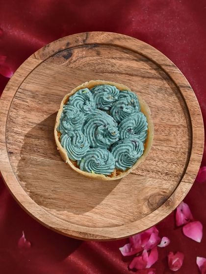 A royal twist on tradition. My blueberry-flavoured ghewar is vibrant, velvety, and oh-so-delicious. A unique treat for Teej.