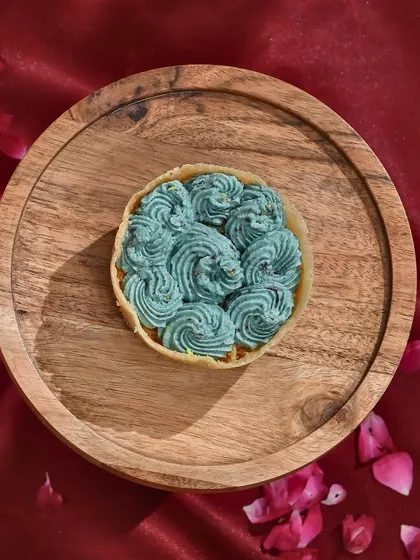 A royal twist on tradition. My blueberry-flavoured ghewar is vibrant, velvety, and oh-so-delicious. A unique treat for Teej.