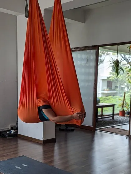 The 'womb' pose in the aerial hammock is deeply restorative, allowing for a moment of quiet and surrender during class.