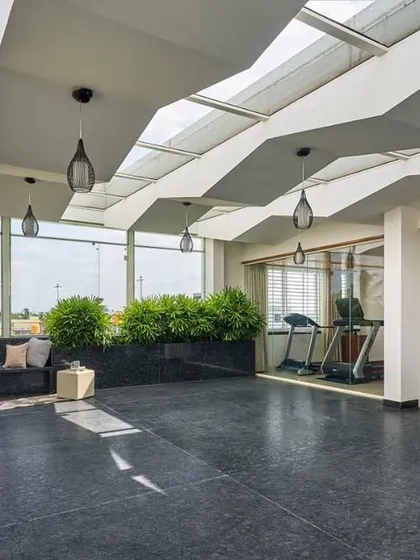 We design spaces for living, not just for shelter. This covered terrace for the 'Wilasa' villa includes a lounge and a home gym, with a lightweight roof structure that allows for ample daylight, creating a perfect space for relaxation and wellness.