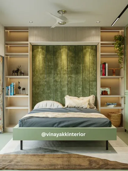 This bedroom design is centered around a calming olive green palette. The plush, vertically paneled headboard serves as a soft, inviting focal point, while the built-in open shelves provide personalized storage for books and decor, making the room both stylish and functional.