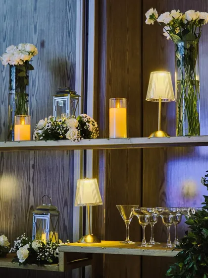 A stylish bar setup for a Sangeet, featuring modern shelving, elegant glassware, and warm ambient lighting.