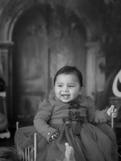 A timeless black and white portrait of the birthday girl. Even without color, her joyful expression and the beautiful setup shine through.