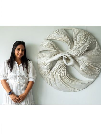 Here I am with "The Awakening Cycle" (Series 2). This all-white version, with its luminous finish, suggests clarity and hope. The hands, held in a gentle mudra, represent the self-love required to evolve.