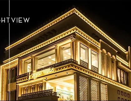 A demonstration of powerful facade lighting on a large commercial-style building. The automated system transitions the building's look from day to night, using Hybec lights to create a brilliant and impressive night view.