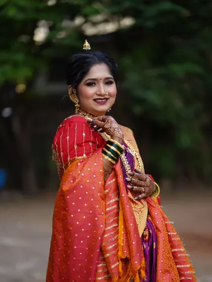 A smiling portrait of our Maharashtrian bride, radiating happiness and confidence in her complete traditional look.