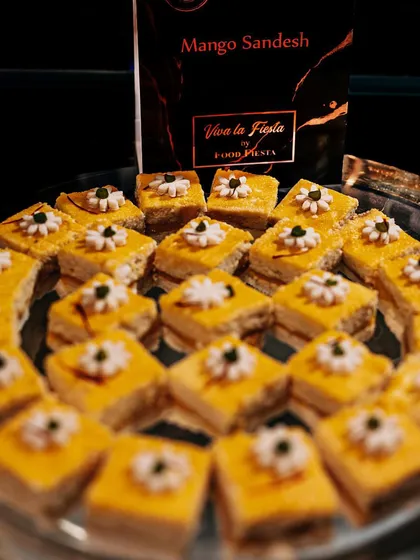 Keep calm and eat Sandesh. A platter of delicate Mango Sandesh, beautifully arranged and garnished. This classic Bengali sweet is a light and elegant option for any dessert spread.