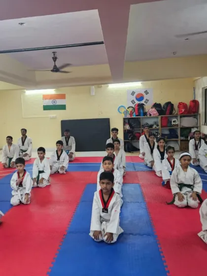 Students kneeling in formation during a belt exam. This moment reflects the discipline and respect that are central to Taekwondo.