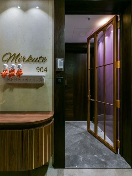 First impressions matter. This unique entrance door in cool metal and clear glass makes a bold statement. A full-size mirror on the opposing wall reflects the space, making the entryway feel even larger.