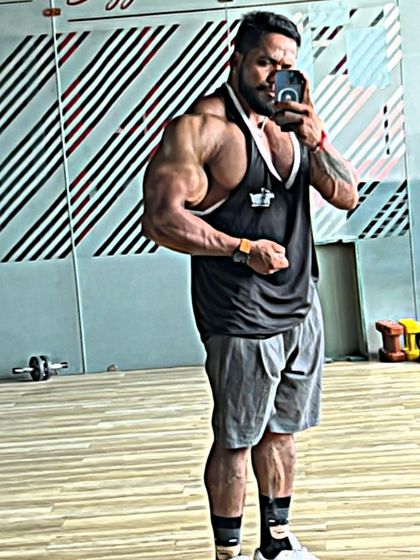 Arm and chest pose in the gym. The grind never stops.