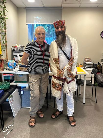 With a student in her classroom. It's a reminder that you can change your habits, and your habits will change your future. This is the essence of Karma Yoga.