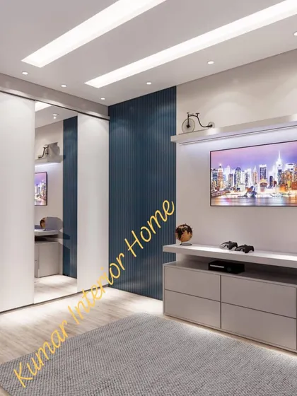 This view shows the TV unit and a sliding wardrobe with a mirrored panel, a great way to make the room feel larger.