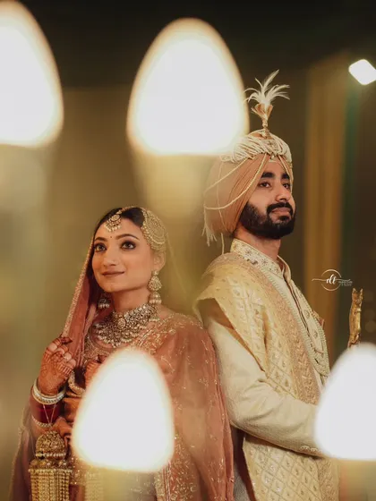A beautiful candid of the Sikh couple. The bride's makeup gives her a radiant glow that looks stunning in the warm, ambient lighting.