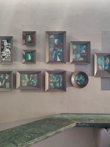 A collection of small, framed canvas paintings created for a commercial space. The series explores abstract forms and figures in a consistent color palette, designed to be viewed as a collective story.