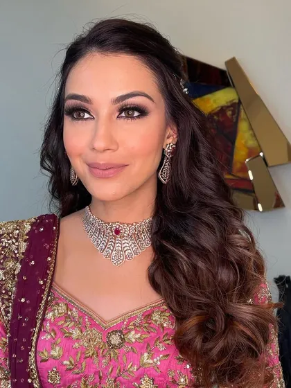 The final sangeet glam look, featuring soft waves and a smokey eye.