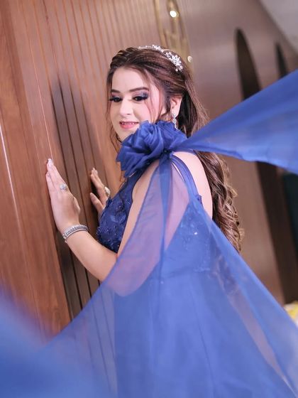 Another angle of the bride in her flowing blue gown. This shot captures the full sweep of the fabric, adding a sense of drama and grandeur to the portrait.